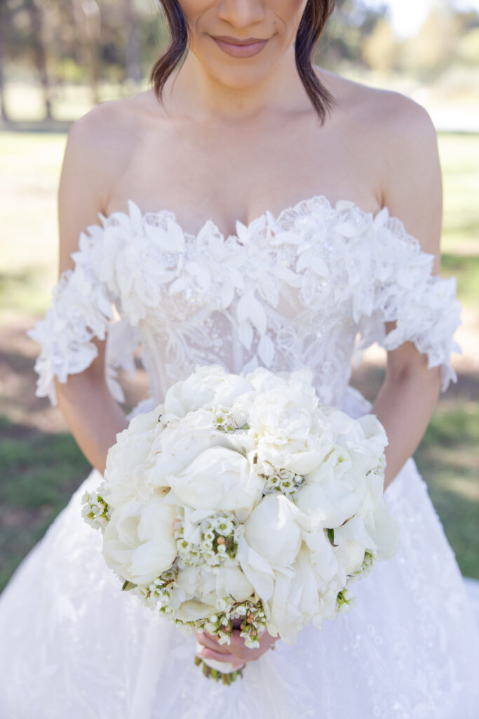 Romantic wedding dress and bouquet detail shot. 