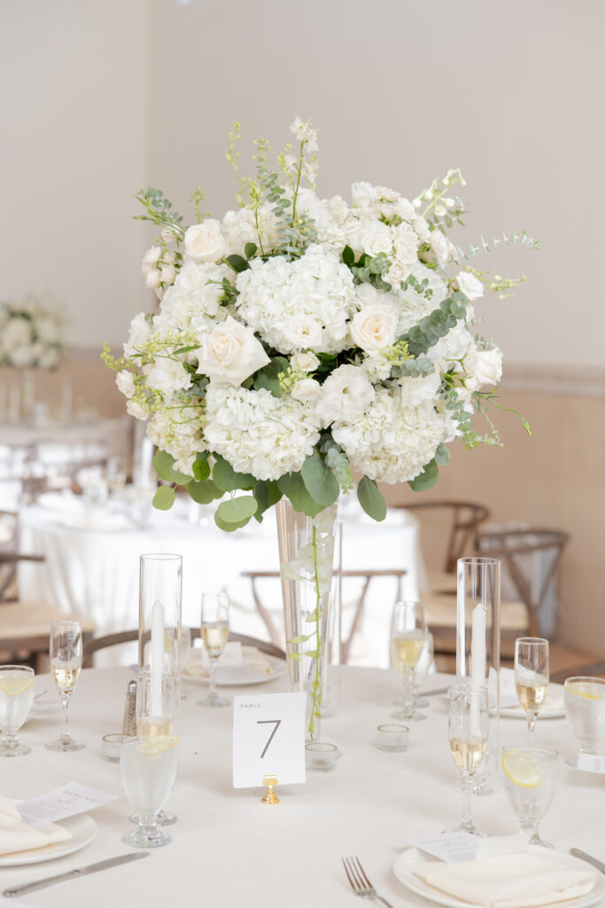 Romantic white wedding table decor details.