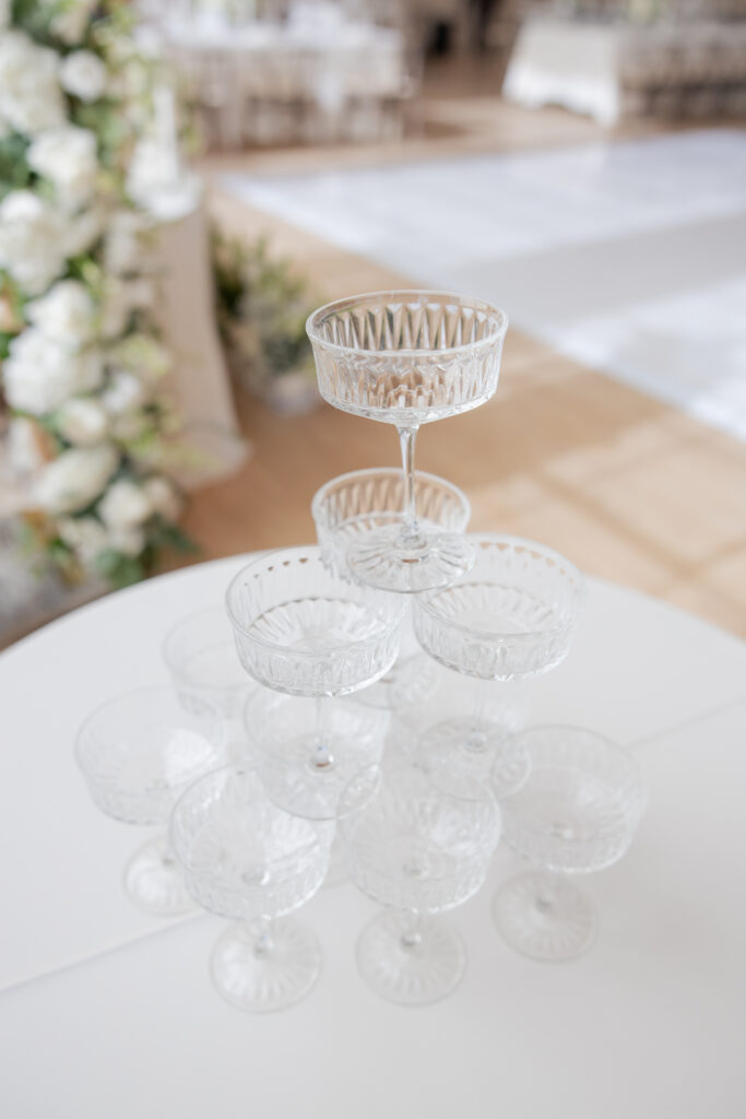 Wedding reception champagne tower coupe glasses.