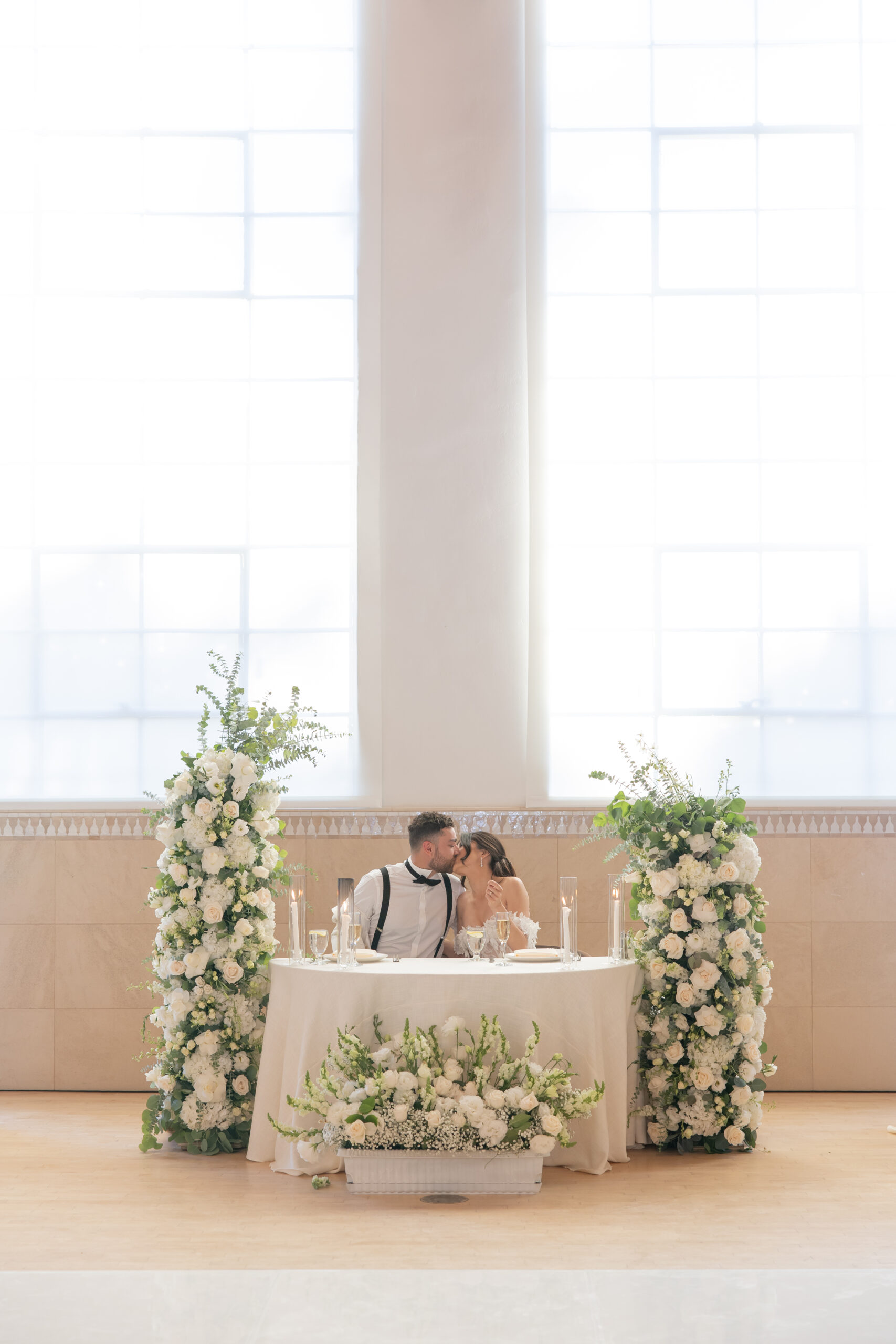 Romantic wedding sweetheart table with freestanding floral arrangements at Grand Gimeno.