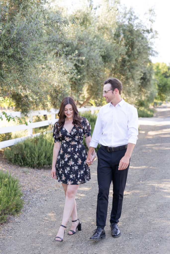 Candid couple walking during their Olive + Lavender Farms engagement session.