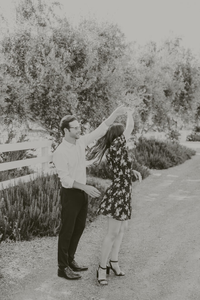 Couple dancing at Olive + Lavender Farms during their engagement session. 