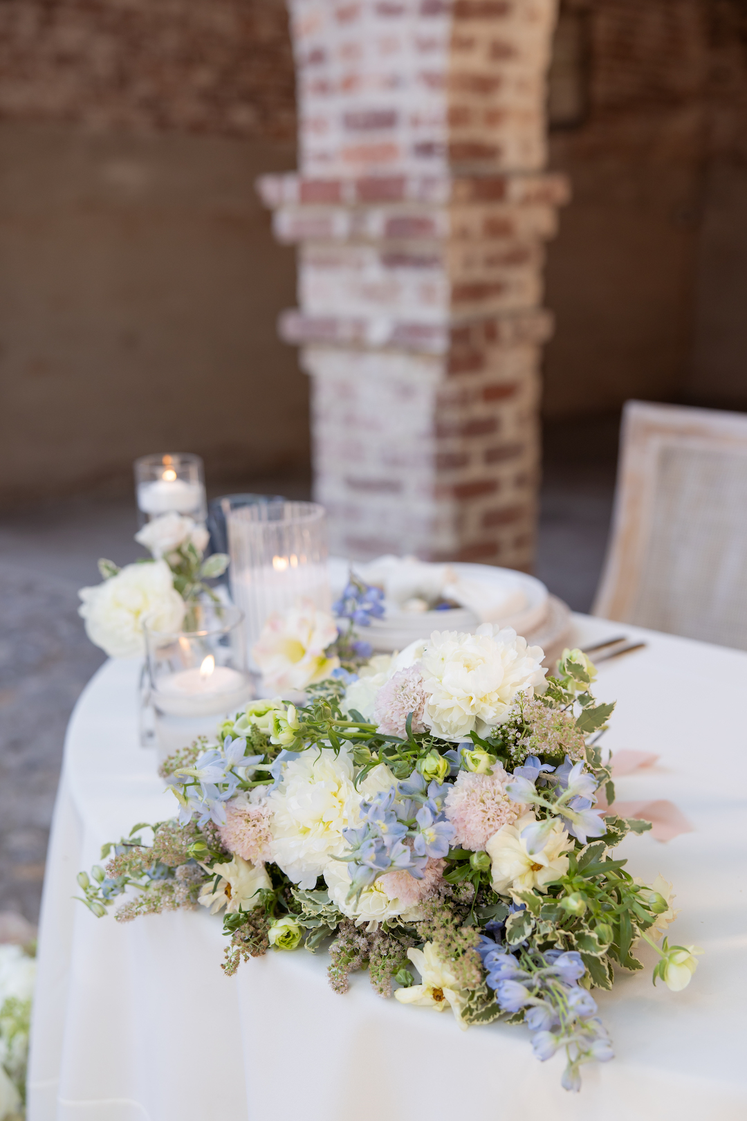 Romantic pastel floral arrangement wedding table decor. 