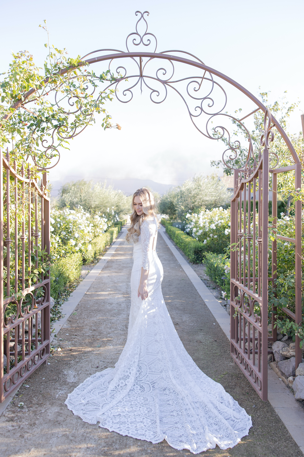 Wedding day bridal portrait at the Tuscan Rose Ranch gate. 