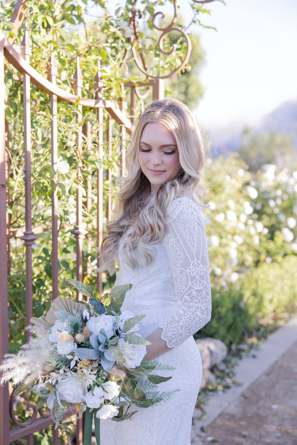 Romantic bridal portrait at Tuscan Rose Ranch with a dusty blue and green bouquet. 
