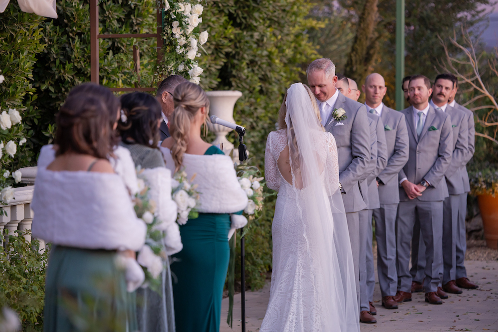Bridesmaid and groomsmen lined up next to the bride and groom during the ceremony at Tuscan Rose Ranch.