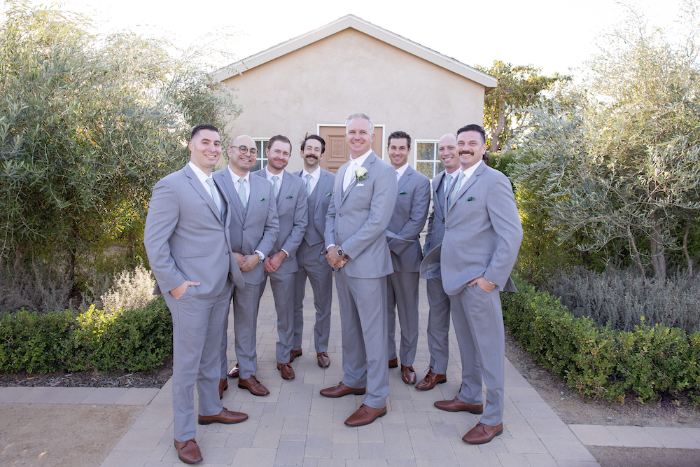 Groom and groomsmen group photo at Tuscan Rose Ranch with all grey suits. 