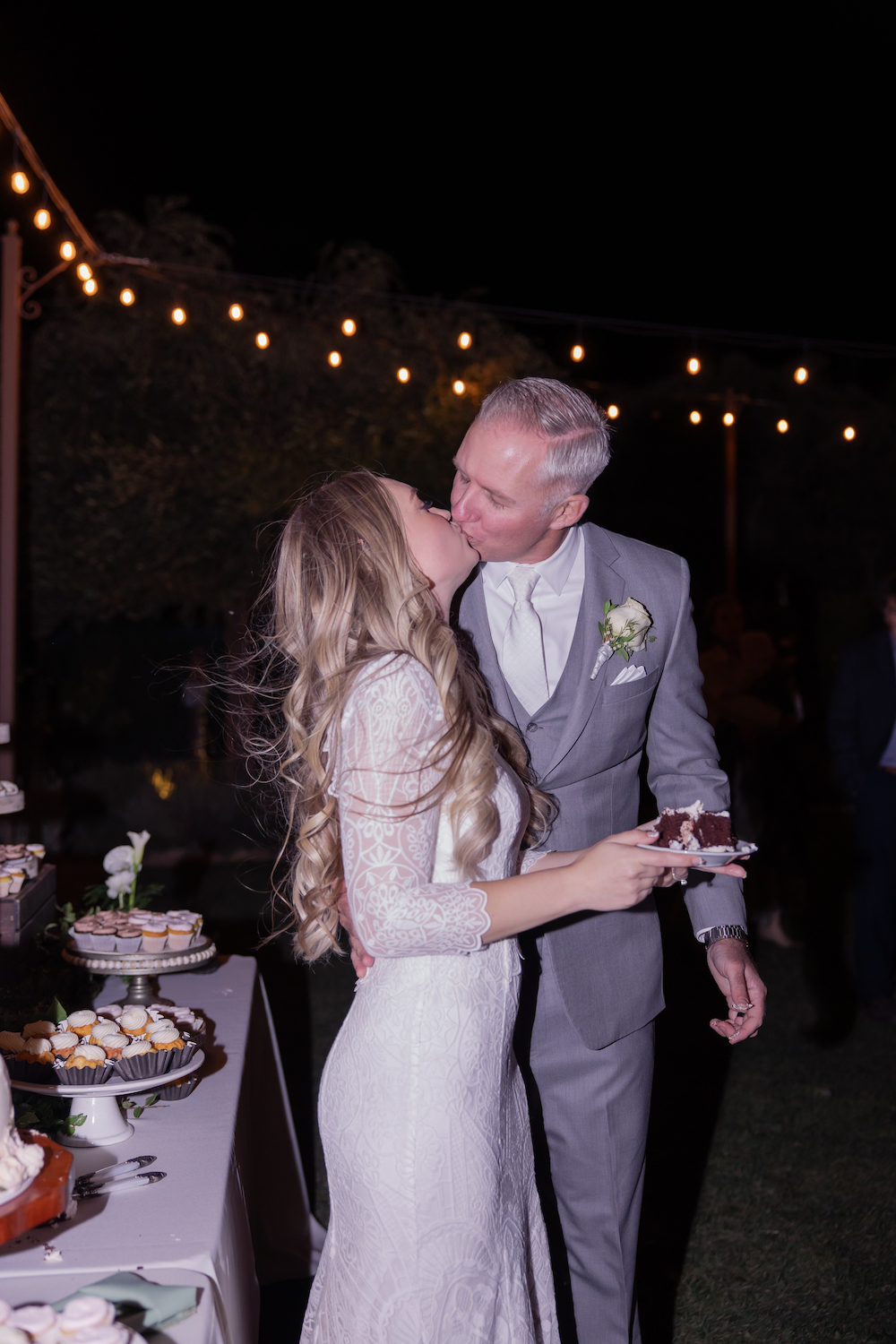 Tuscan Rose Ranch wedding bride and groom kiss after the cake cutting.